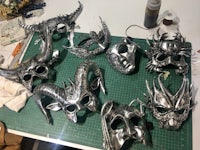 a group of metal masks on a cutting board