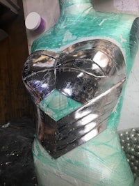 a mannequin with a silver torso covered in plastic