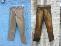 a pair of tan pants hanging on a blue wall