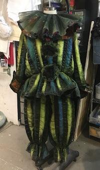 a clown costume is on display in a workshop