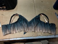 a pair of black and blue bras on a table