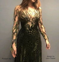 a woman in a green dress is posing for a photo