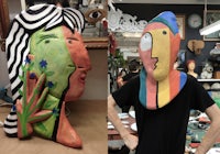 a man wearing a colorful mask in a workshop