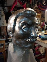 a silver head is being made in a workshop