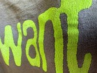 a close up of a t - shirt with the word want written on it