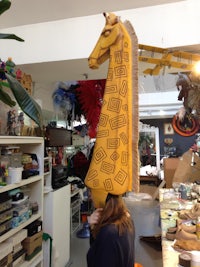 a woman wearing a giraffe head