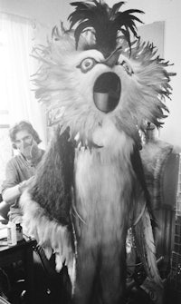 a black and white photo of a man in a costume