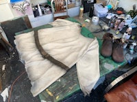 a piece of clothing is sitting on a table in a workshop