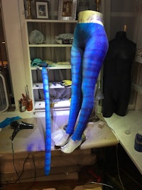 a pair of blue leggings on a mannequin
