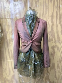 a mannequin wearing a pink jacket