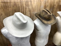three mannequins with cowboy hats on them