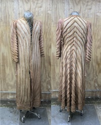 a mannequin with a brown coat on it