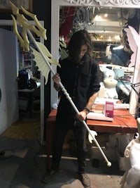 a man standing in front of a mirror with a sword