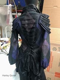 a mannequin wearing a black and purple dress