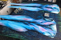 a pair of blue and white painted leggings on a table