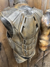 a mannequin with a metal vest on it