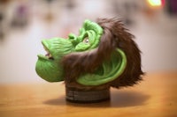 a green gorilla head on a table