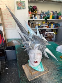 a sculpture of a woman's head on a table
