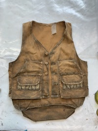a brown leather vest is sitting on a table