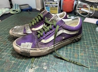 a pair of vans old skool sneakers on a table