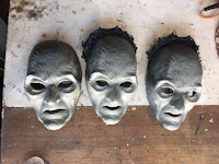 three masks are sitting on a table next to each other