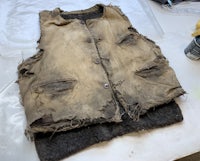 a worn out vest sitting on top of a table